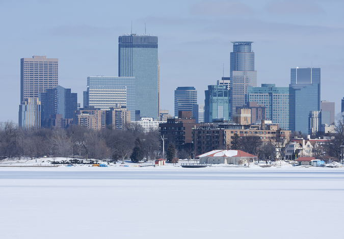 Minneapolis skyline across a frozen river – cold and long winters in the city